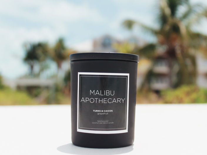 Mini Matte candle in the Turks & Caicos grapefruit scent on Grace Bay Beach in Turks & Caicos